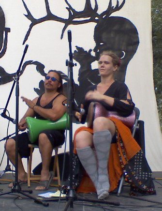 Melanie Rose Maxwell performing hand percussion on stage